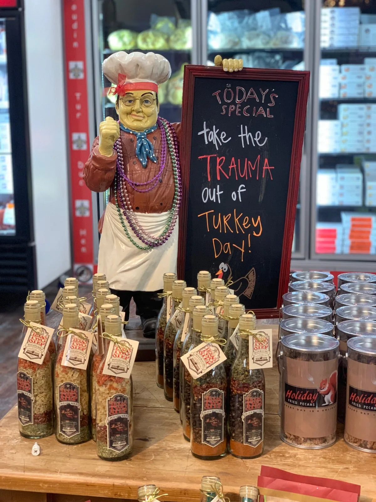 Cajun chef statue beside Cajun seasoning bottles