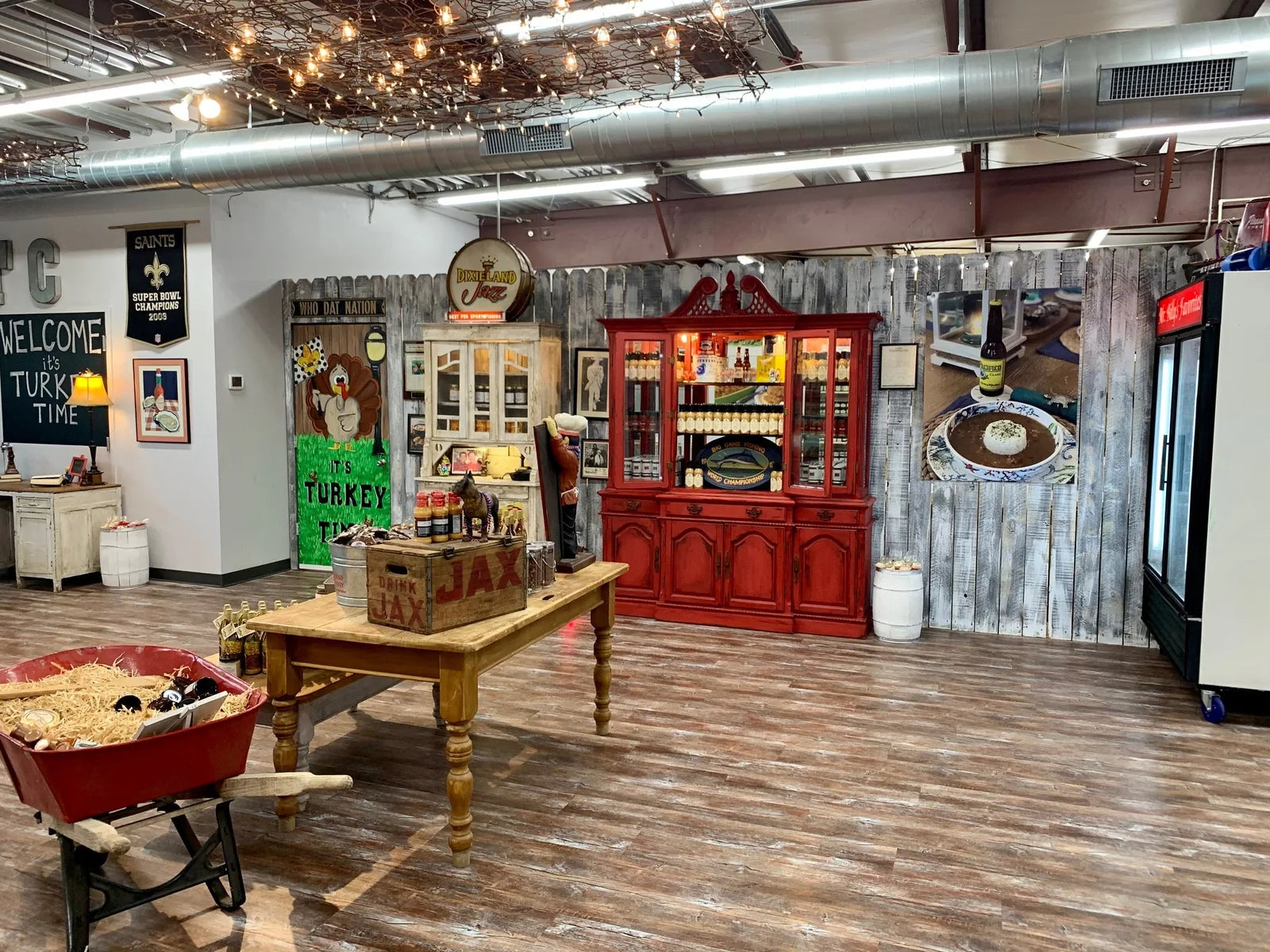 Store interior with red hutch, harvest table and rustic decor